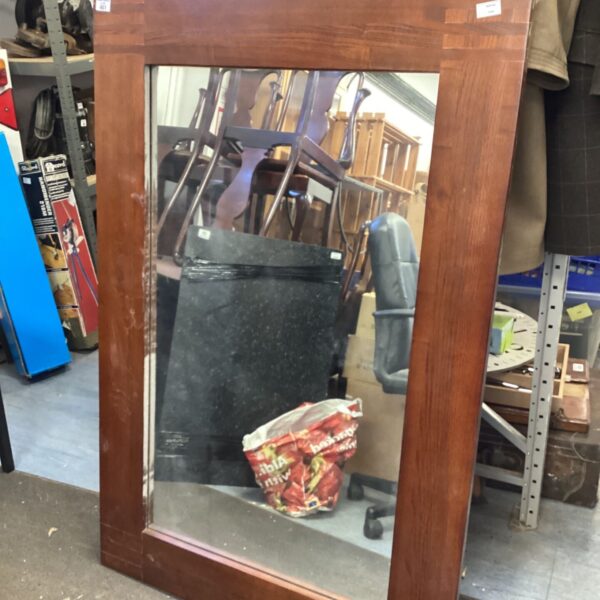 Large dark wood wall mirror for home decor.