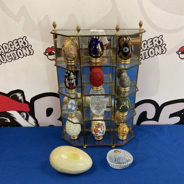 Tiered display case showcasing a decorative egg collection.
