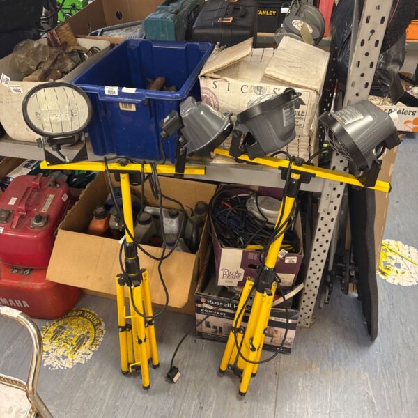 Pair of Defender tripod halogen site lights for construction or outdoor use.