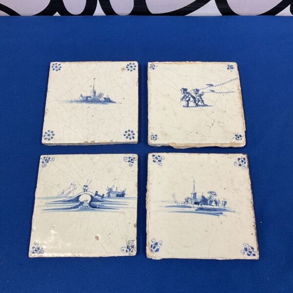 Vintage Delft blue and white tiles with charming scenes.