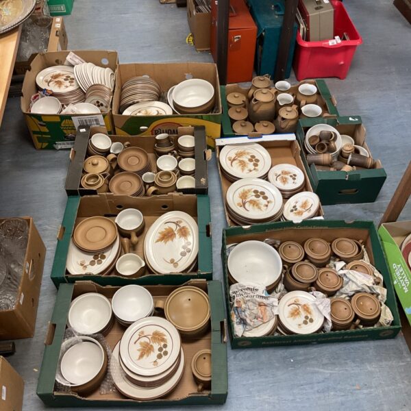 Large collection of brown Denby stoneware plates and bowls.