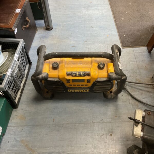 Dewalt DC013 worksite radio with visible wear and tear.