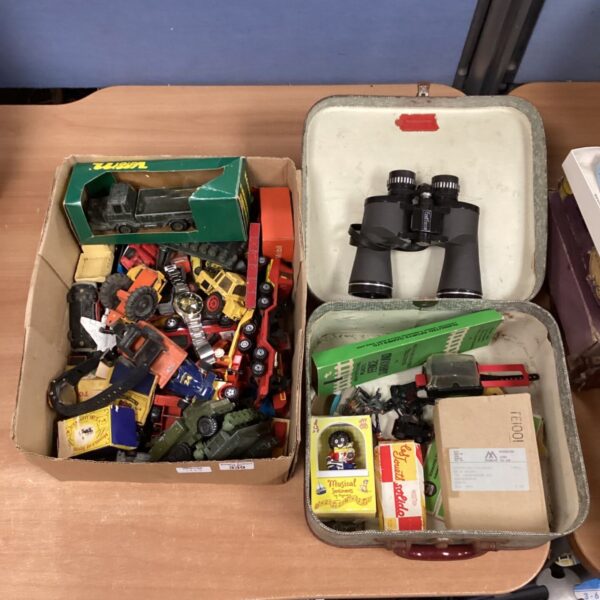 Mixed lot of vintage diecast vehicles and binoculars for collectors.