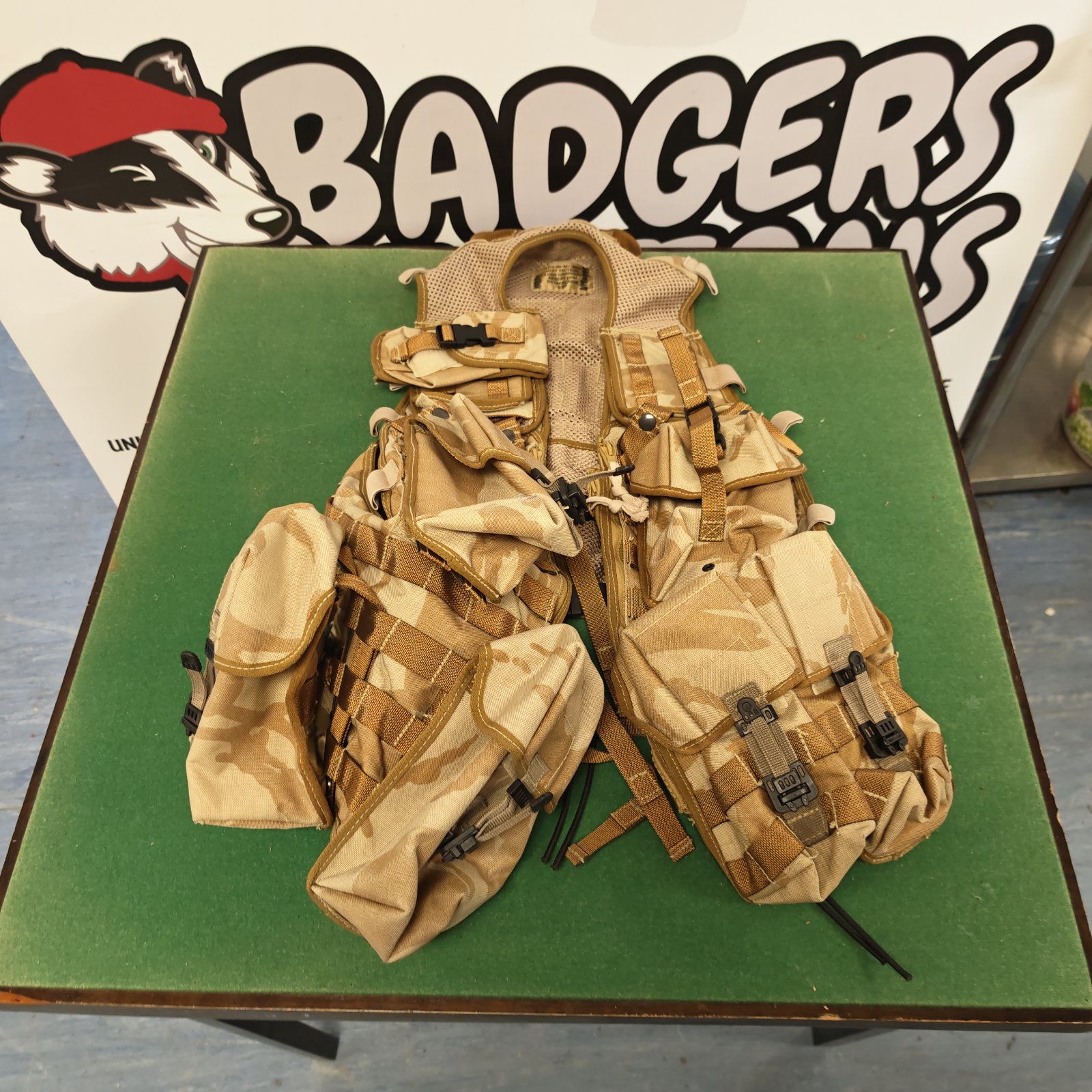 Desert DPM tactical vest with multiple pouches and adjustable straps.