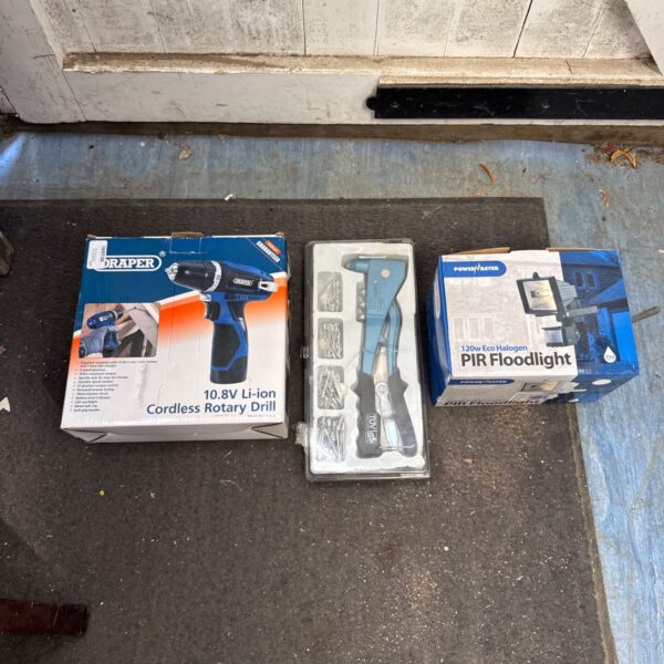 Draper cordless drill set with rivet gun and floodlight in packaging.