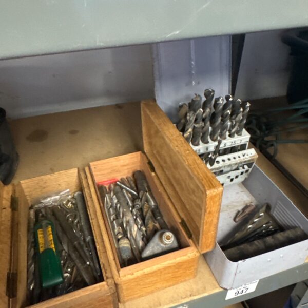 Assorted drill bits and punches in wooden tubs, workshop tools.