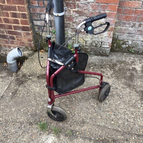 Red Drive Medical rollator walker with a wire basket.