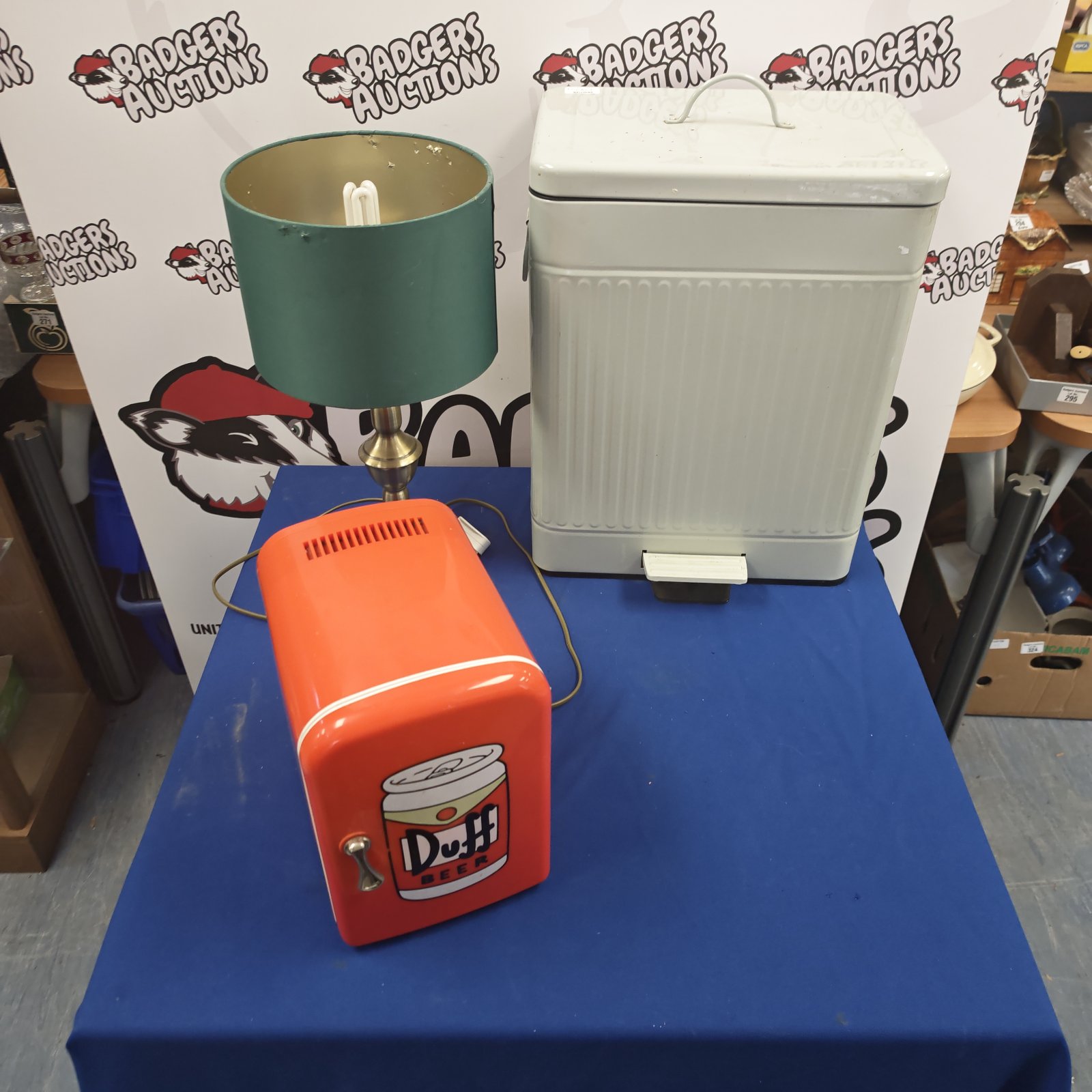 Duff Beer mini fridge, foot pedal bin and table lamp lot.