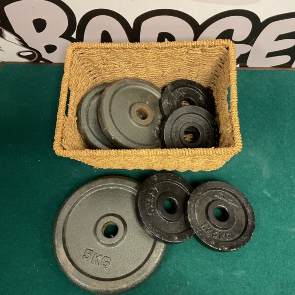 Basket of 5KG metal dumbbell weights for fitness.
