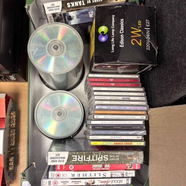 Mixed lot of DVDs and CDs for home entertainment and storage.