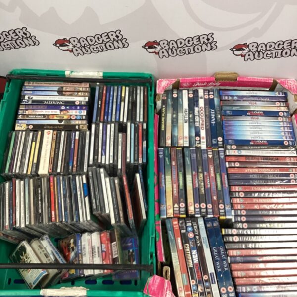 Tray of mixed DVDs and CDs for sale.