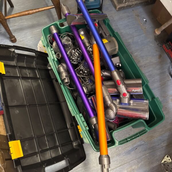 Dyson cordless vacuum parts stored in a large tub.