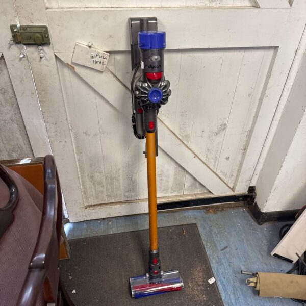 Dyson V8 Absolute cordless vacuum cleaner with charger, side view.