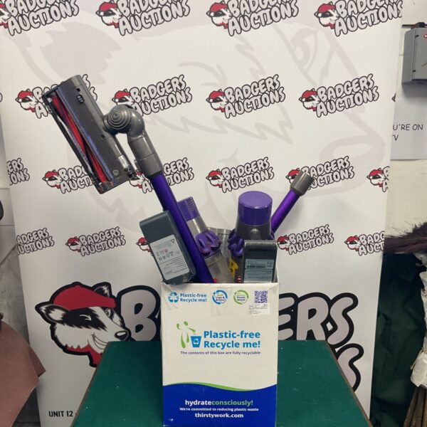 Box of Dyson vacuum cleaners and attachments for home cleaning.
