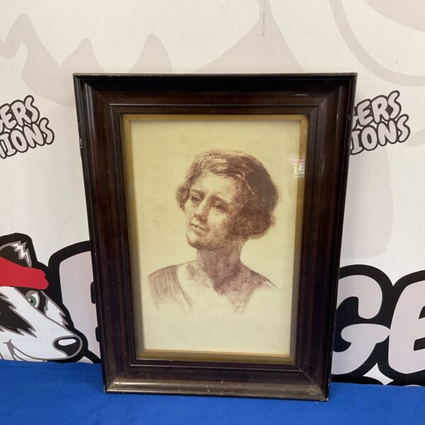 Early 20th-century sanguine portrait of a pensive woman in a frame.