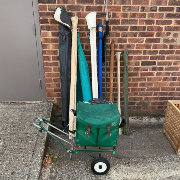 Vintage Efgeeco Rover fishing trolley with bundled rods and netting.