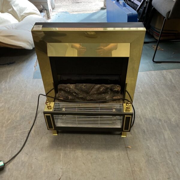 Vintage electric fireplace with log effect and brick surround.