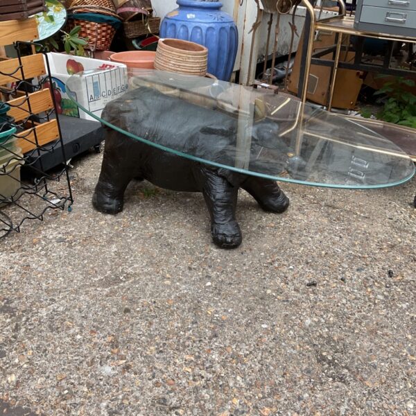 Vintage elephant coffee table with glass top, unique furniture piece.