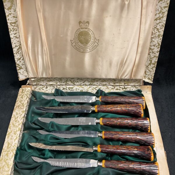 Vintage Empire Sheffield steak knife set with faux horn handles.