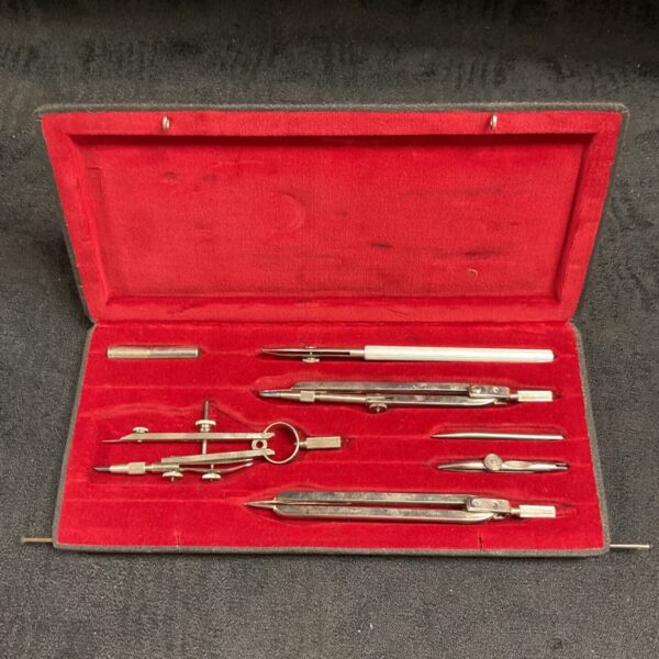 Vintage Emu drawing instrument set open in red case.