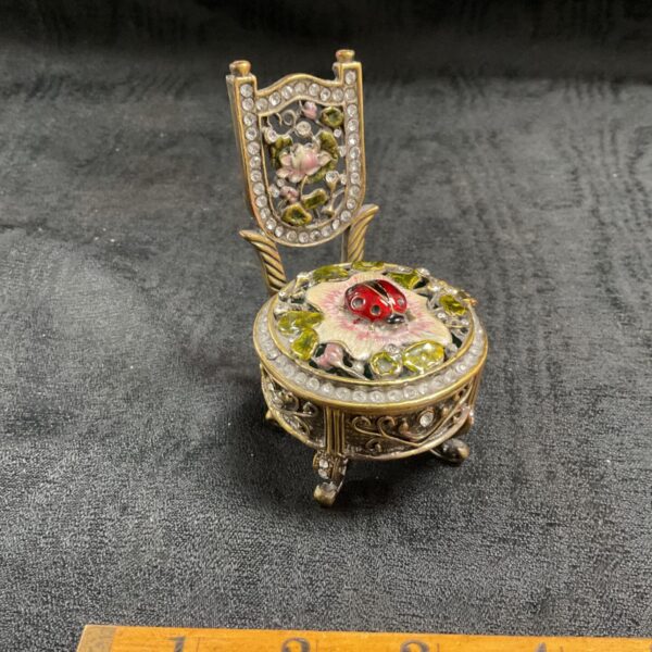 Detailed enamel ladybug chair trinket box with rhinestones.