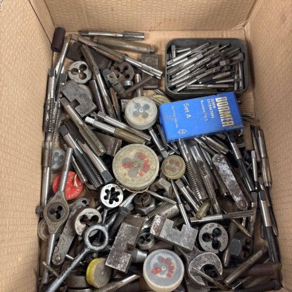 Tray of vintage engineering tools including taps, dies and extractors.