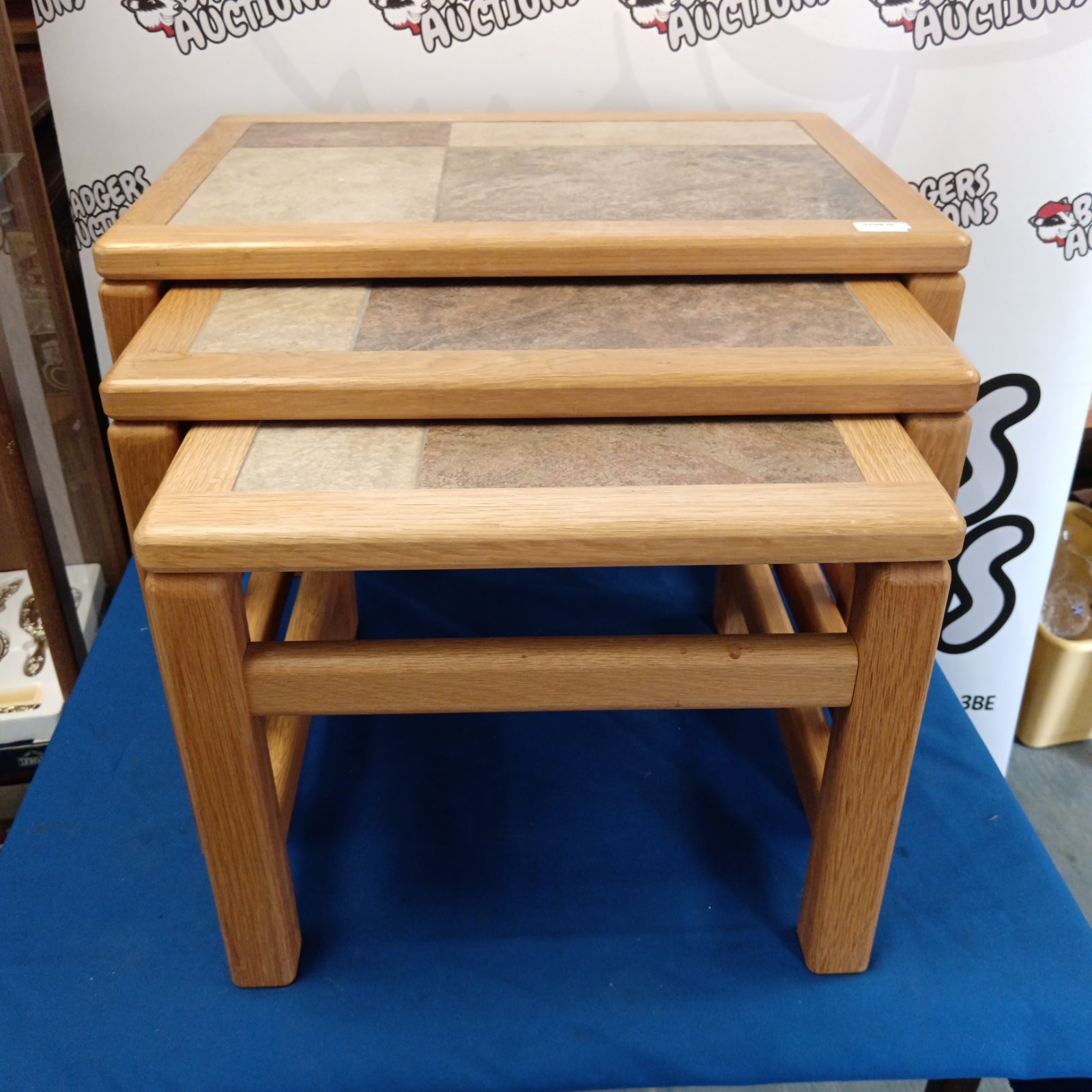 Vintage Ercol style nest of tables with tile tops in warm tones.