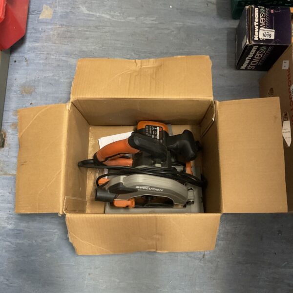 Evolution circular saw inside cardboard box, showing tool condition.