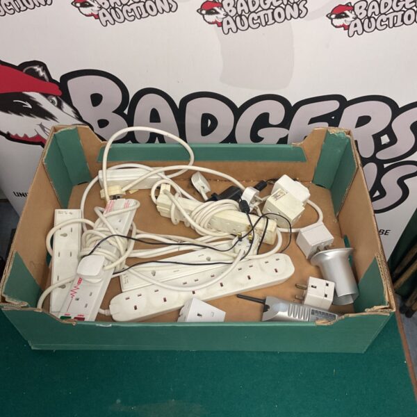 Mixed lot of extension cables and plugs for household electrical use.