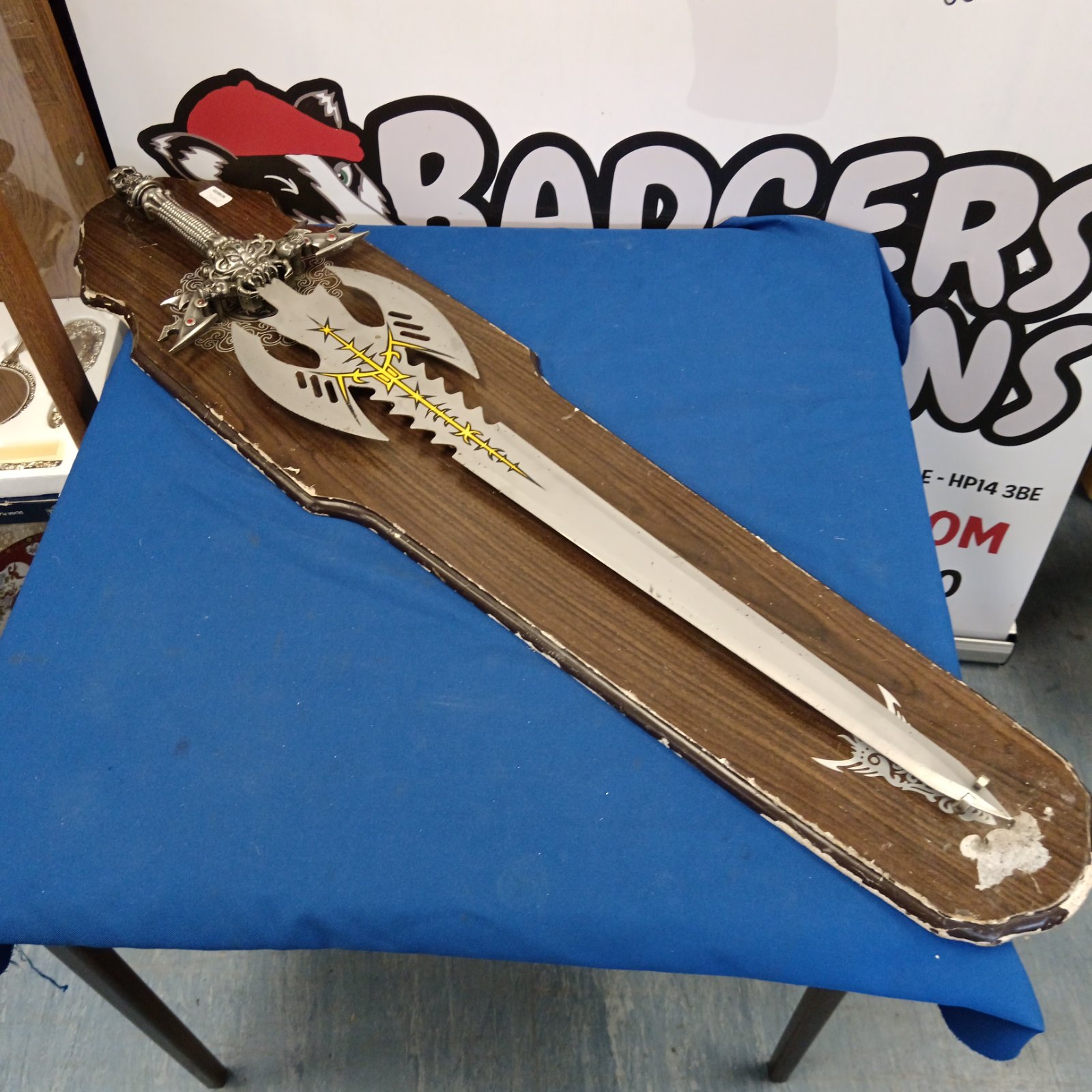 Large fantasy sword with wall mount for display.
