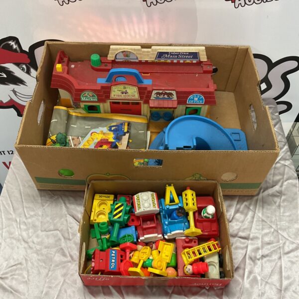Vintage Fisher Price Main Street playset with buildings and accessories.