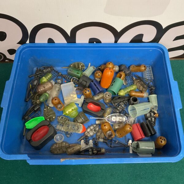 Tray of assorted plastic fishing feeders for carp fishing.