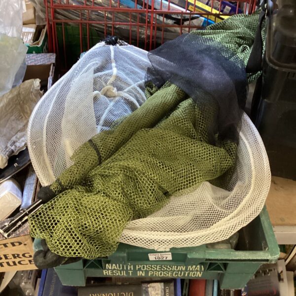 Tray of used fishing landing nets and rod rests for angling.