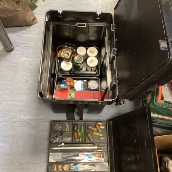 Open fishing tackle box showing weights and floats inside.