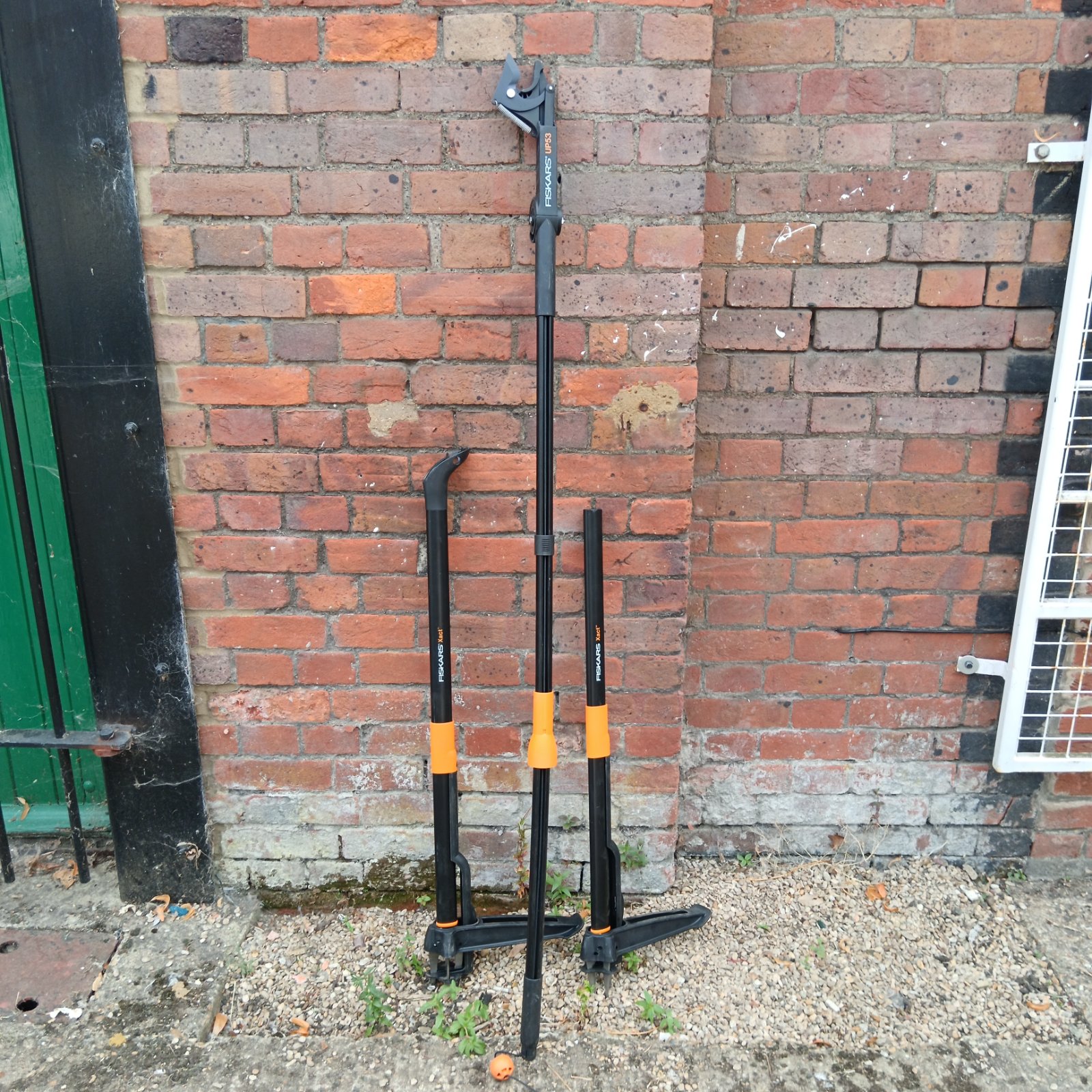 Fiskars gardening tools lot including weed puller and loppers.