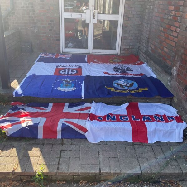 Collection of vintage flags including US military and Union Jack.