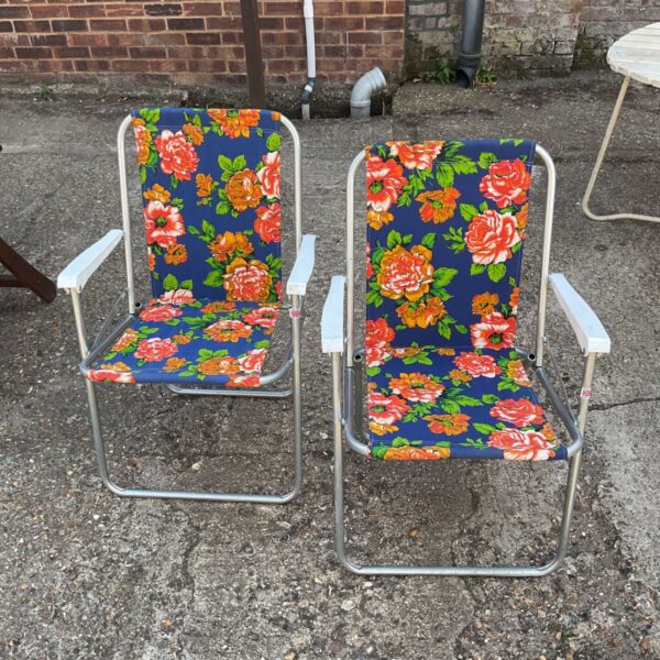 Vintage floral folding garden chairs for outdoor use.