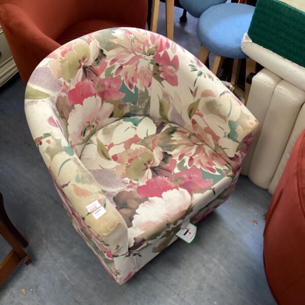 Vintage floral tub chair with a colourful patterned upholstery.
