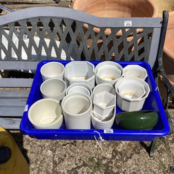 Tray of twelve plastic flower pot holders for garden plants.