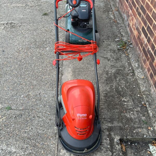Red Flymo Vac 250 electric lawnmower, vintage garden tool.