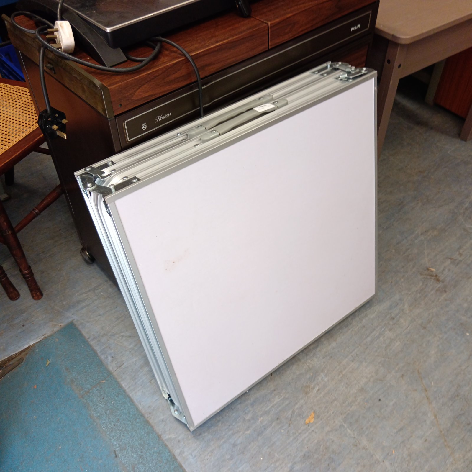 Aluminium folding camping table shown indoors.