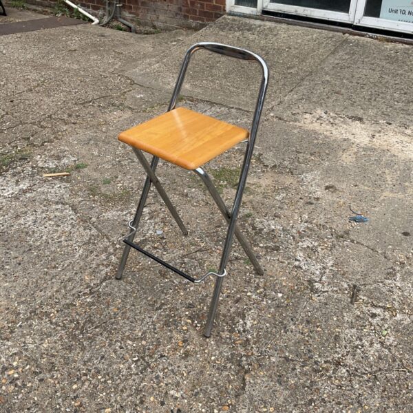 Vintage folding kitchen stool with chrome frame and pine seat.