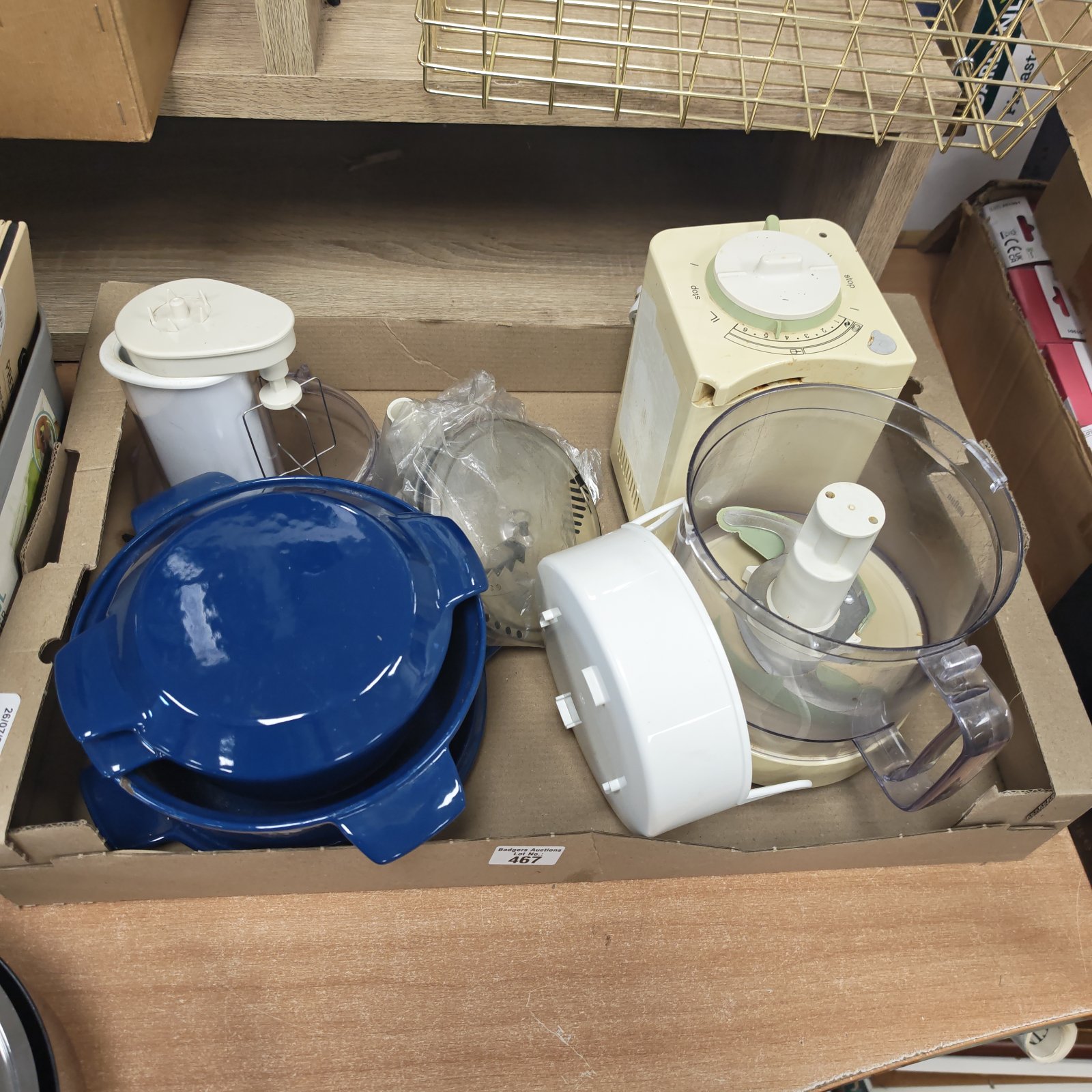 White electric food processor with casserole dishes in background.