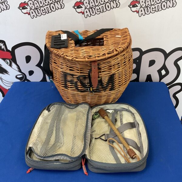 Vintage Fortnum and Mason wicker creel basket with fishing accessories.