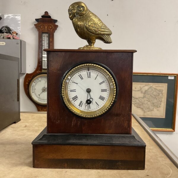 Antique French mantle clock with brass owl finial.