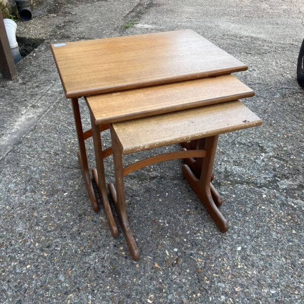 Vintage G Plan teak nesting tables with iconic sleigh legs.