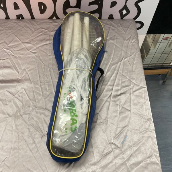 Green carry bag containing a vintage garden badminton set with rackets.