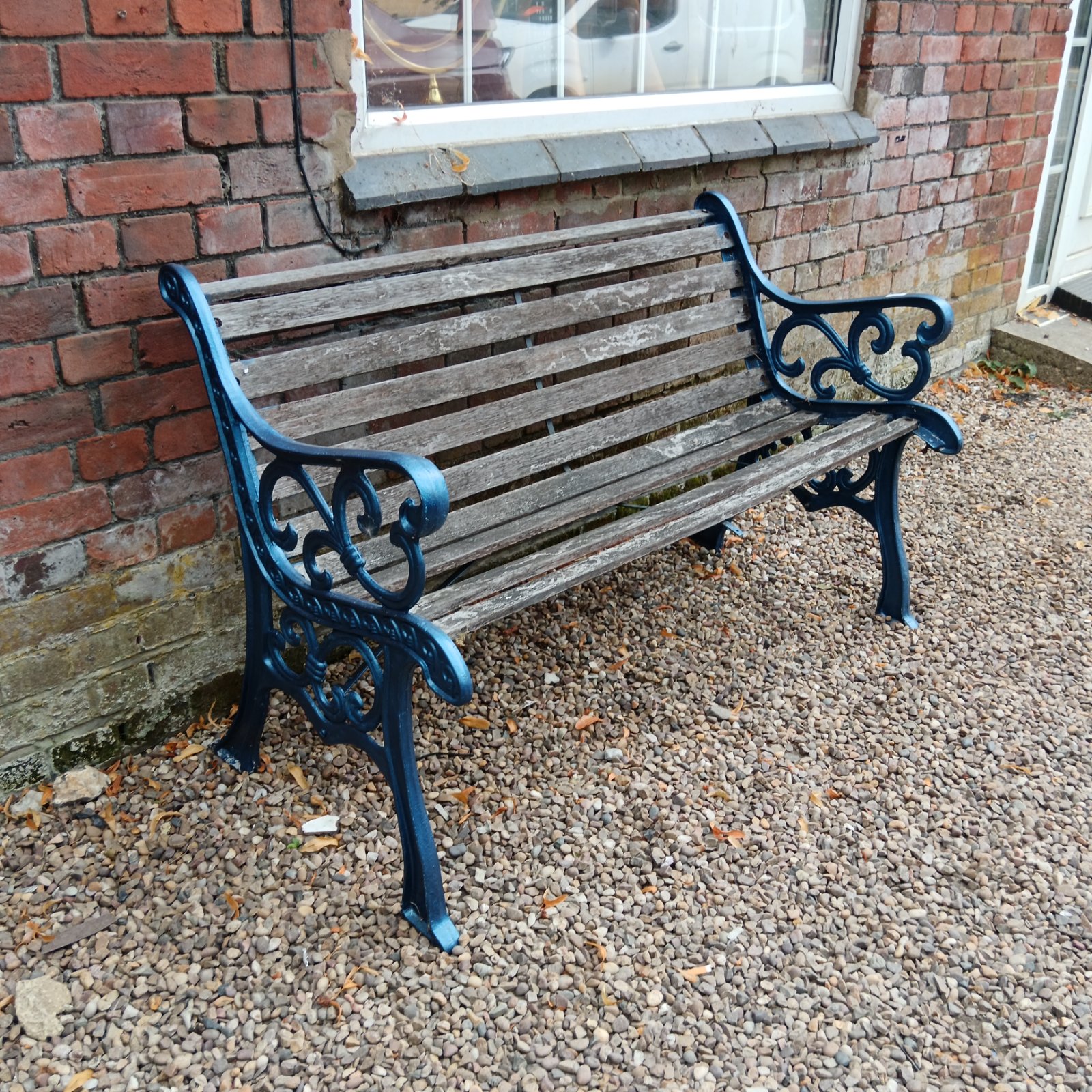 Antique garden bench with ornate cast iron details and weathered wood.