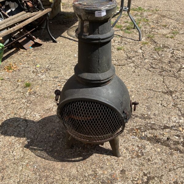 Rustic cast iron garden chiminea for outdoor heating and ambiance.