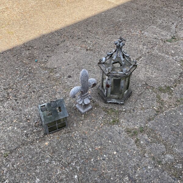 Antique wrought iron garden lanterns, a vintage outdoor lighting pair.